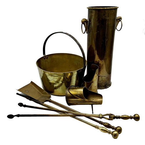 628 - Brassware lot to include an antique jam pan with iron loop handle, a set of fire irons, two shell ca... 