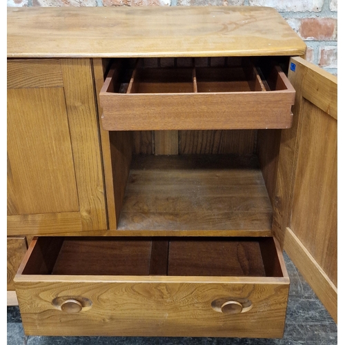 1238 - Vintage Ercol light elm sideboard, three cupboard doors over two drawers, 76.5cm high x 130cm long, ... 