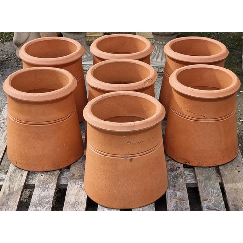 1038 - Seven terracotta chimney pots, 31cm high