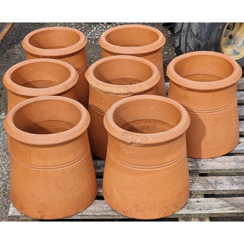 1038 - Seven terracotta chimney pots, 31cm high