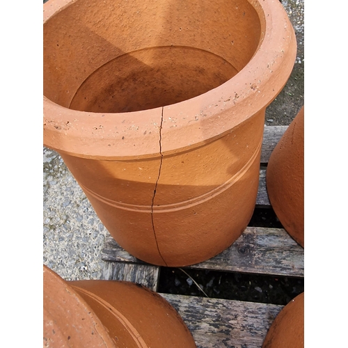 1038 - Seven terracotta chimney pots, 31cm high