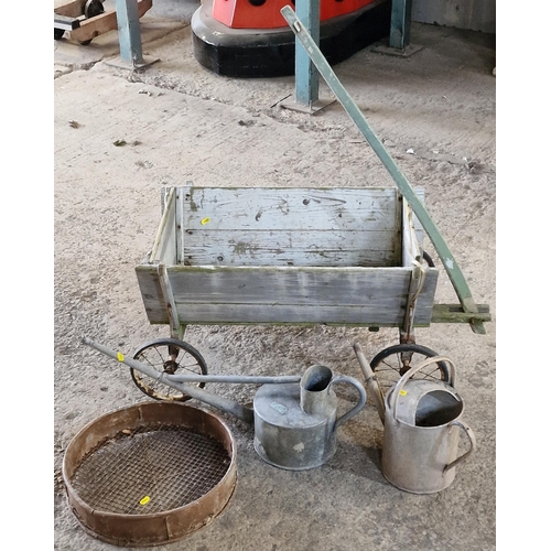 1045 - Vintage wooden wheelbarrow 41cm high x 90cm wide together with two galvanised watering cans and a wi... 