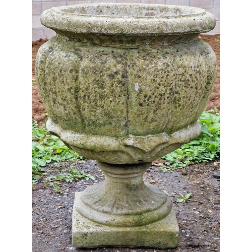 1059 - Large reconstituted stone garden urn with lobed bowl raised on a pedestal base, 57cm high x 41cm wid... 