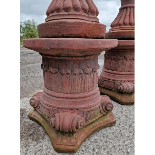 1062 - Pair of reconstituted stone garden urns with lobed bowls and flared rims, raised on Corinthian colum... 