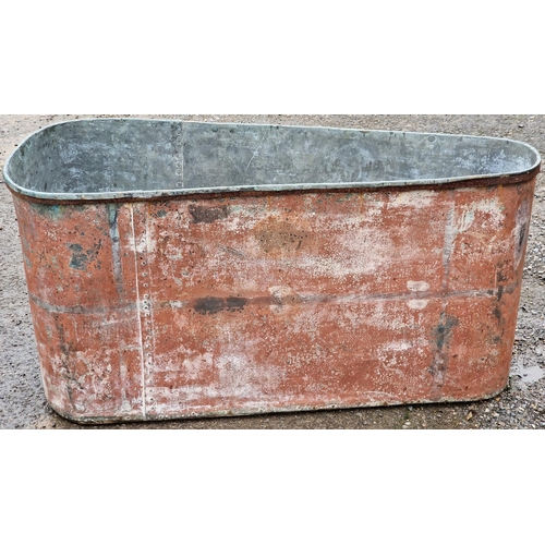 1069 - Vintage galvanised trough of triangular form with rivetted seams, 63cm high x 131cm wide