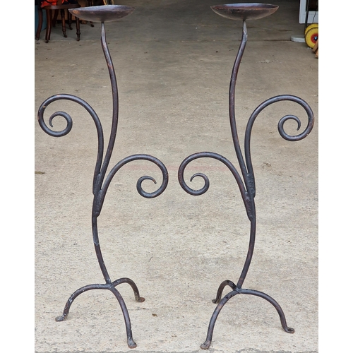 1074 - Pair of scrolled wrought iron candlesticks, 119cm high