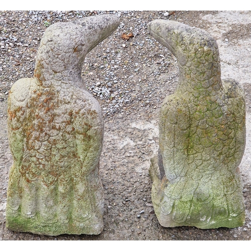 1076 - Pair of weathered garden ornaments in the form of ravens, 61cm high