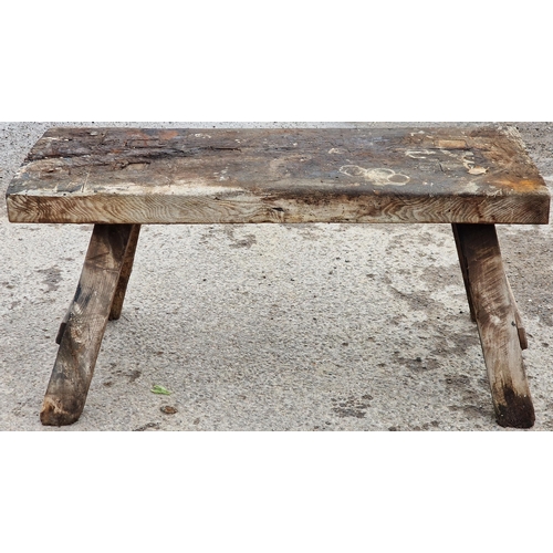 1079 - Antique rustic pig bench with rectangular top raised on square supports, 60cm high x 125cm wide x 65... 