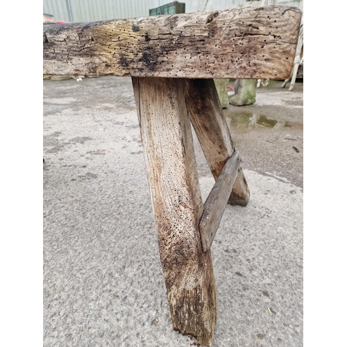 1079 - Antique rustic pig bench with rectangular top raised on square supports, 60cm high x 125cm wide x 65... 