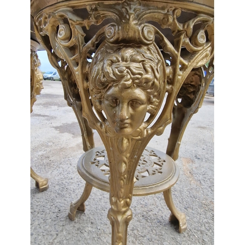 1092 - A pair of gilt cast iron 'Britannia Head' pub tables with gilt painted finish, 72cm high x 61cm diam... 