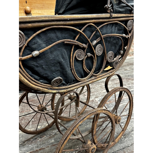 1333 - Antique wicker pram with pierced scrolling detail and fabric hood, 88cm high