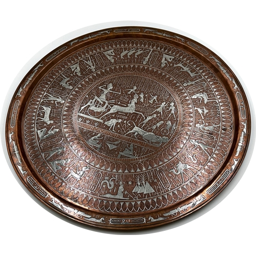 670 - Large copper and silver applied Egyptian charger with various figures and scenes, 65cm diameter.