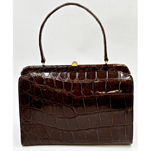 364 - A stunning 1940s brown crocodile skin handbag. Hardware in gilt metal with clasp opening to the top ... 