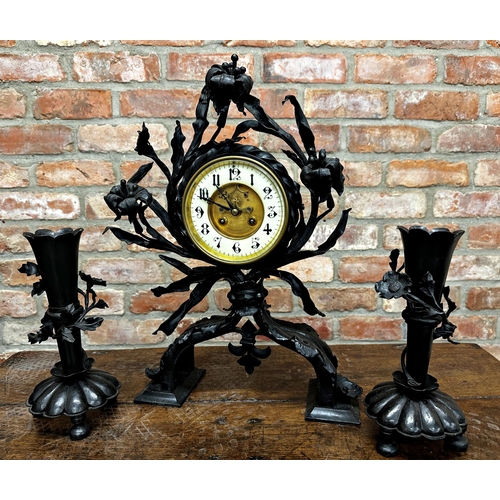 84 - Interesting Arts and Crafts wrought iron floral clock garniture with twin vases, visible escapement ... 