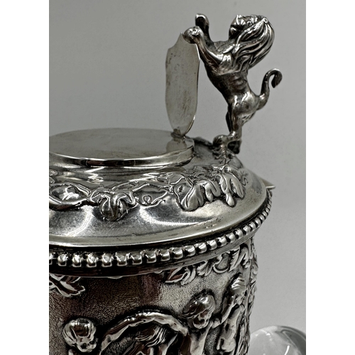 302 - Good quality antique continental 925 silver and cut glass claret jug, the silver top with lion and s... 