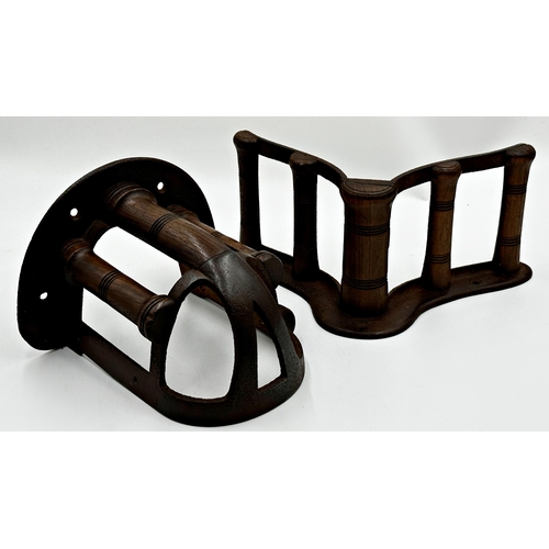 606 - Two antique cast iron and turned wooden saddle racks by Musgrave, the largest 33cm long (2)