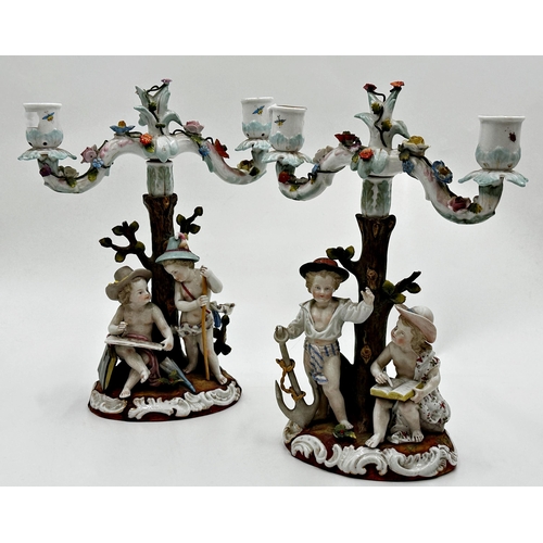 423 - Pair of 19th century Dresden porcelain twin branch candelabra, each mounted by playful children, 29c... 