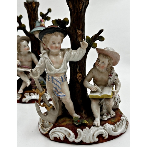 423 - Pair of 19th century Dresden porcelain twin branch candelabra, each mounted by playful children, 29c... 