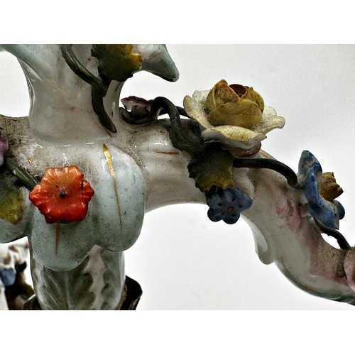 423 - Pair of 19th century Dresden porcelain twin branch candelabra, each mounted by playful children, 29c... 