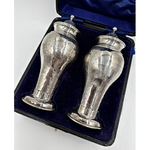 311 - Superior quality cased pair of silver casters, with hammered finish and Art Nouveau foot rim, maker ... 