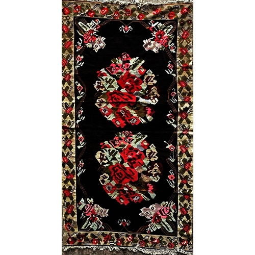 1593 - Good quality possibly Balkan flat weave carpet, with roses on a black ground L395 x W190