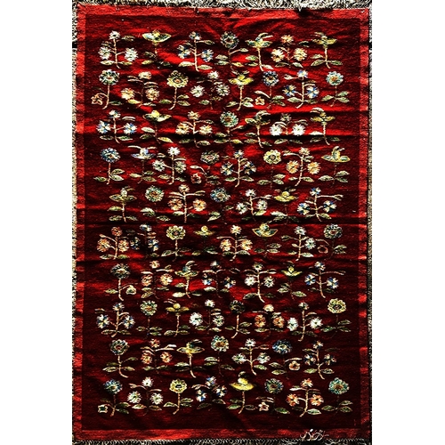 1594 - Possibly Balkan carpet, decorated with floral sprays on a red ground L320 x W195cm