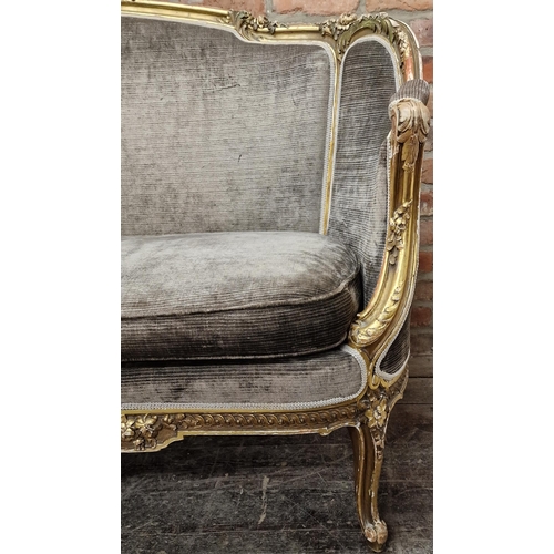 1323 - 19th century French giltwood and gesso salon couch, the open frame work carved with flowers with a g... 