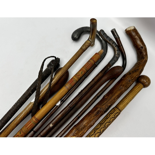 747 - Collection of ten various walking sticks/canes to include a silver topped crooked bamboo shafted exa... 