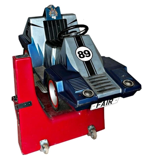 1122 - Plug in, coin operated child’s fairground ride-on racing car. Not currently running.
Takes 20p

Meas... 