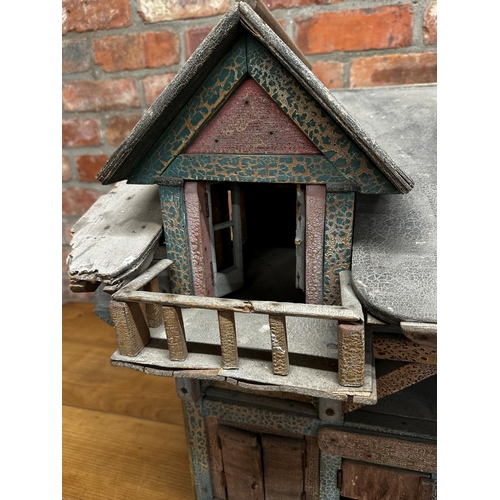 252 - Good large Folk Art dolls house of a stable building, with original paint and shutter doors and wind... 