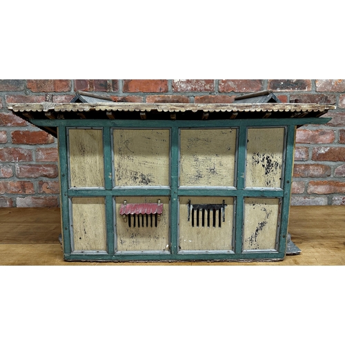 252 - Good large Folk Art dolls house of a stable building, with original paint and shutter doors and wind... 