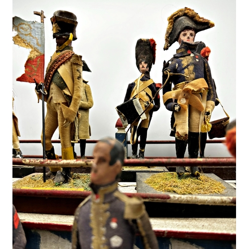 253 - Good late 19th century Folk Art diorama of hand crafted Napoleonic figures on a painted two tier sta... 