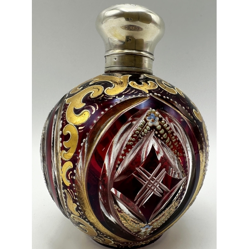 166 - Antique continental bohemian cranberry glass scent bottle with silver lid and gilt and enamel overla... 