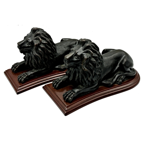 312 - Good quality pair of bronze recumbent lions, on shaped wooden plinth bases, 19cm high x 32cm long (2... 