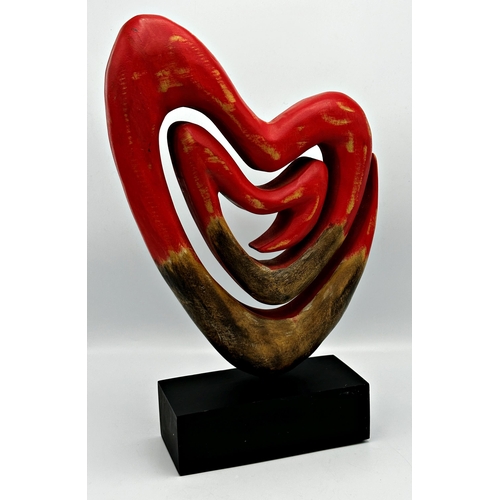 2271 - 20th Century school stylised carved wooden heart upon a plinth base, 42cm high