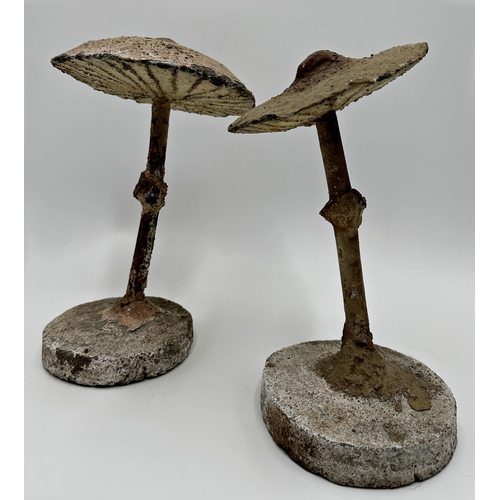 391 - Pair of reconstituted stone and steel mushrooms with hand painted decoration, 27cm high (2)