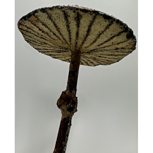 391 - Pair of reconstituted stone and steel mushrooms with hand painted decoration, 27cm high (2)