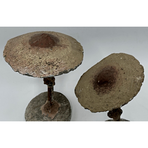 391 - Pair of reconstituted stone and steel mushrooms with hand painted decoration, 27cm high (2)