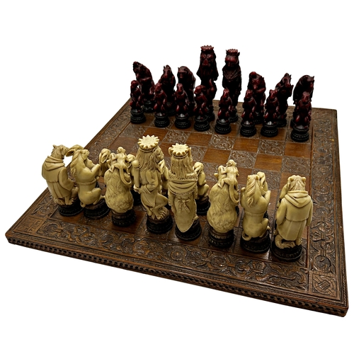 400 - Large novelty resin chess set, of various wild animals in human dress, height of king 19cm, on a gam... 