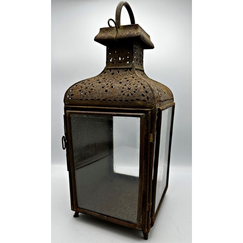 2189 - 19th century pierced sheet metal storm lantern with three glass panels, 52cm high