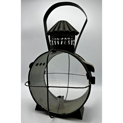 2191 - 19th century circular pierced sheet metal storm lantern, two caged glass panels, 40cm high