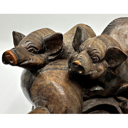 260 - Eastern hardwood carving of overlapping pigs, 13cm high x 25cm long