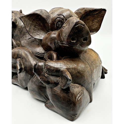 260 - Eastern hardwood carving of overlapping pigs, 13cm high x 25cm long