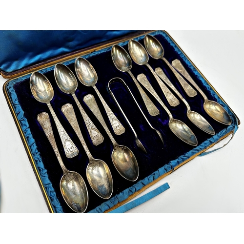 1224 - Good quality Arts & Crafts Scottish silver cased suite of twelve teaspoons and sugar tongs, with eng... 