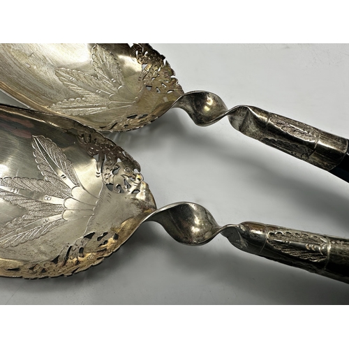 1225 - Pair of eastern '800' silver and horn salad servers, 26cm long with set on eleven African silver apo... 