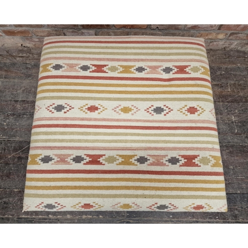 2392 - Large contemporary kilim upholstered footstool with studded edging, carved detail, raised on turned ... 