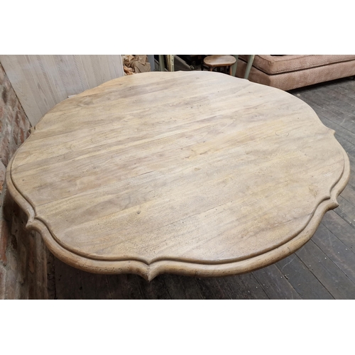 2403 - Contemporary limed oak dining table of serpentine form by Oka, raised on quadrupled base with sabre ... 