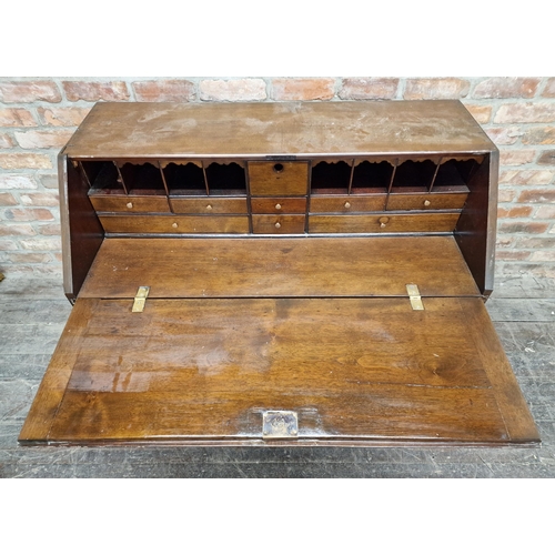 2404 - Georgian oak bureau with fall front, fitted interior, four graduated drawers, raised on bracket feet... 