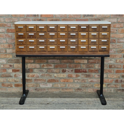 2255 - Vintage bank of thirty six filing drawers raised on associated metal base, H 129cm x W 145.5cm x D 4... 