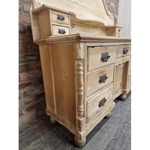 2410 - Victorian pine dresser with shaped back fitted with an arrangement of eleven drawers and central cup... 